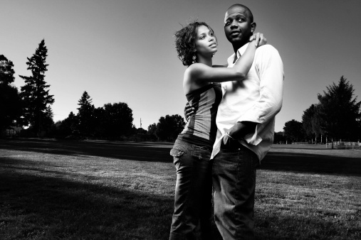 young black couple in a field in the summer