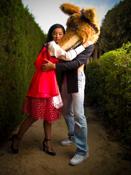 Woman Dressed as Red Riding Hood Hugging Wolf red riding hood asian women in stockings stock pictures, royalty-free photos & images