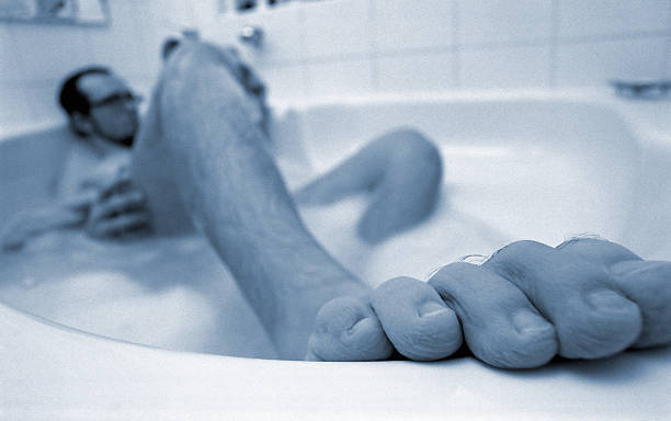 istock Young Man is Relaxing in Bathtub in Bathroom, Blue toned 108129347
