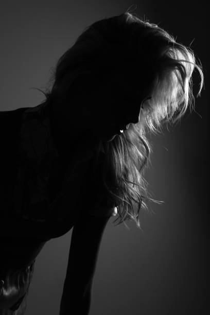 Brunette woman in black dress in studio
