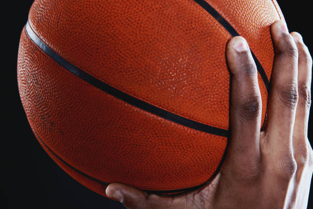 istock Basketball in close-up held by player's hand 1081296714