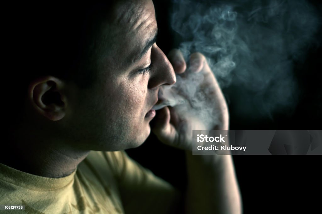 Smoker [2] A man smoking cigarette (focus is set at his face). Addict Stock Photo