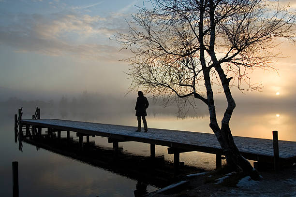 istock Silhouette of a person alone on a dock 108129883