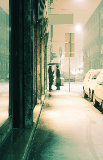 A time for an old and long forgotten shots: a winter street scene with a modest snowstorm.