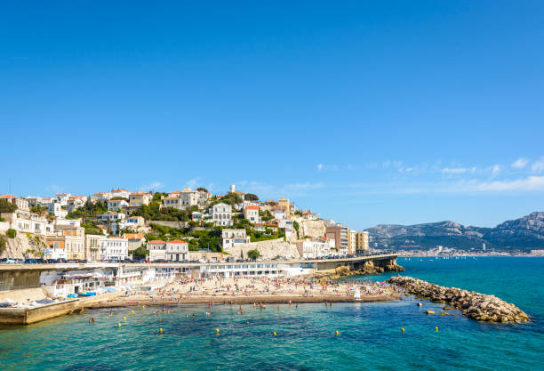 General view of the Prophet beach in Marseille, France. General view of the Prophet beach in Marseille, France, a very popular family beach located on the Kennedy corniche, on a hot and sunny spring day. corniche stock pictures, royalty-free photos & images