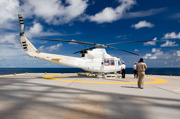 Helicopter taking off near commercial dock at sunset