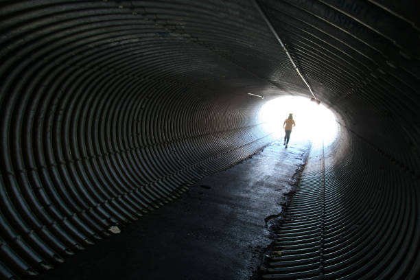 istock Woman Jogging Through Round Metal Tunnel 108130166
