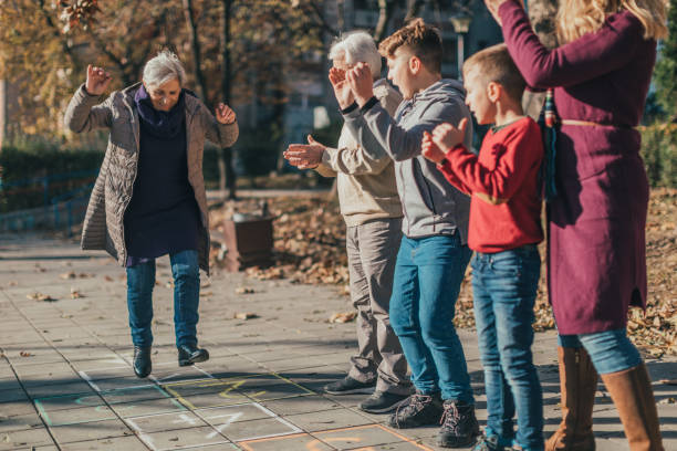 istock Multigenerational family having fun playing hopscotch 1081309270