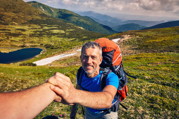 istock A helping hand high in the mountains in the summer hike. 1081313504