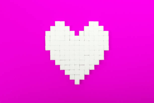 istock Heart of sugar cubes, pink background 1081317494