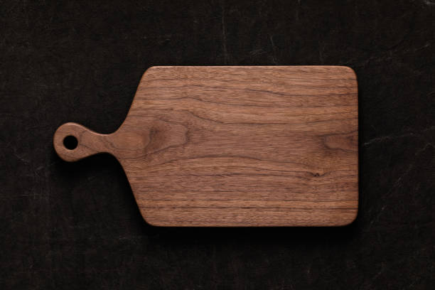 istock Handmade walnut chopping board on handmade tie dyed burlap 1081318108