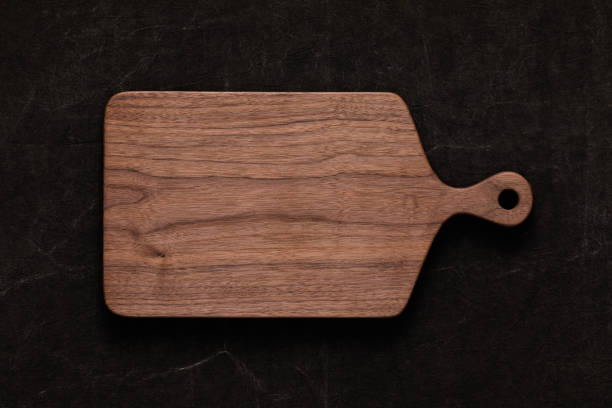 istock Handmade walnut chopping board on handmade tie dyed burlap 1081320874