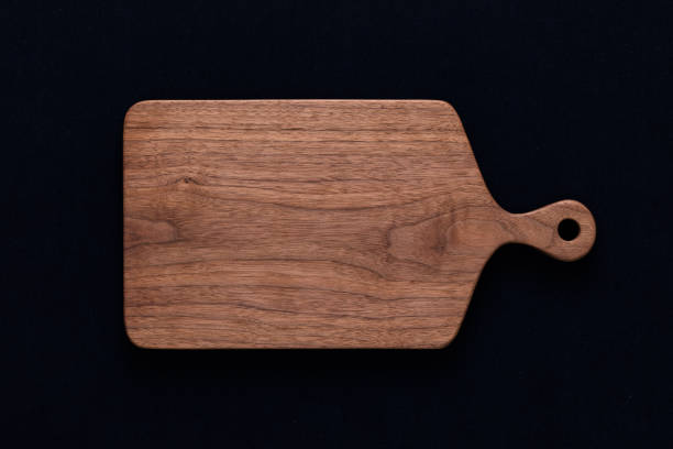istock Handmade walnut chopping board on black cotton 1081321304