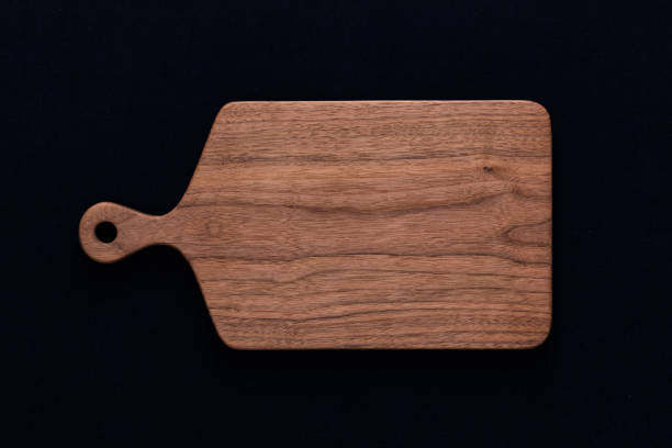 istock Handmade walnut chopping board on black cotton 1081321782