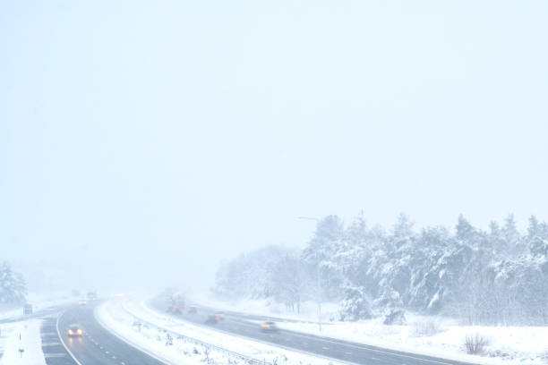 istock Traffic on a highway during a snow blizzard in winter 1081323050