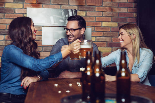 istock Group Of Friends Enjoying Evening Drinks In Bar 1081332692