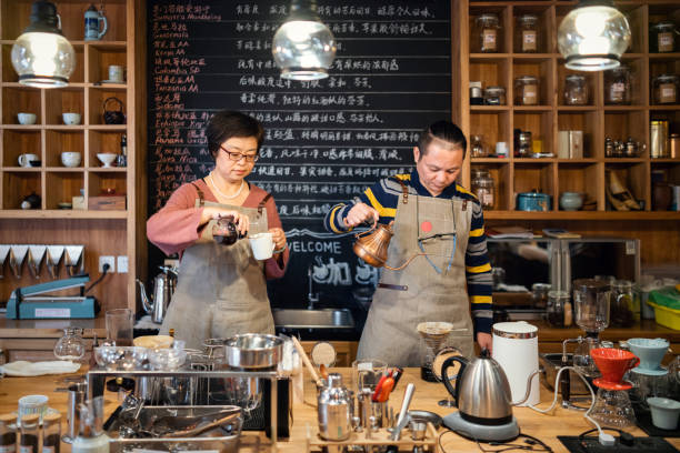 istock Chinese couple working in a coffee shop 1081336622