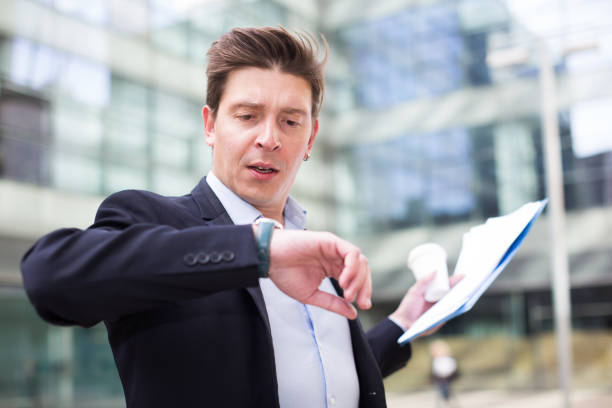 istock Man in jacket with documents hurrying to meeting 1081336698