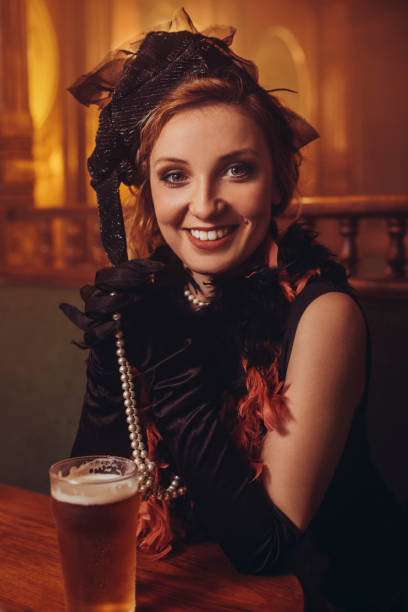 istock Celebration Retro pub Old-fashioned young woman drinking beer Party 1081338422