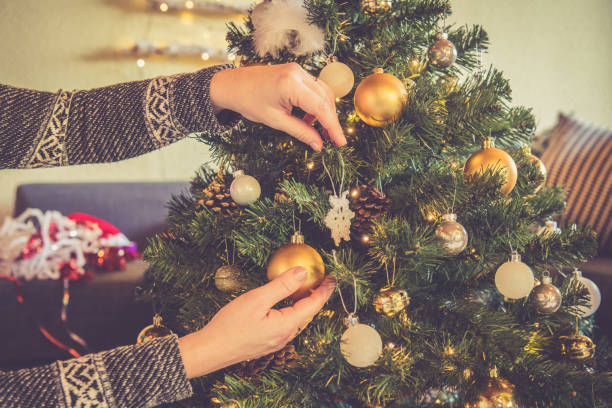istock Woman Hands Close Up decorating Christmas tree 1081338742