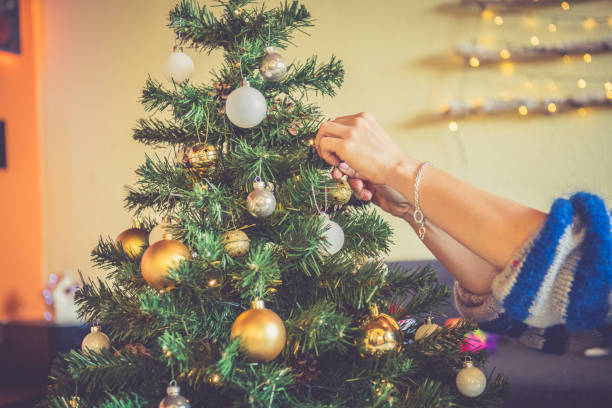 istock Woman Hands Close Up decorating Christmas tree 1081338846