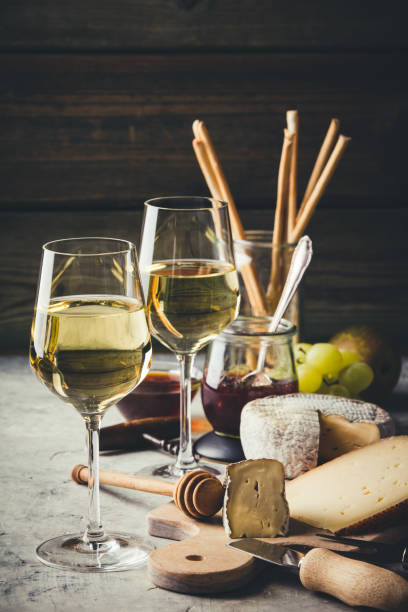 istock White wine with charcuterie assortment on the stone background 1081349206