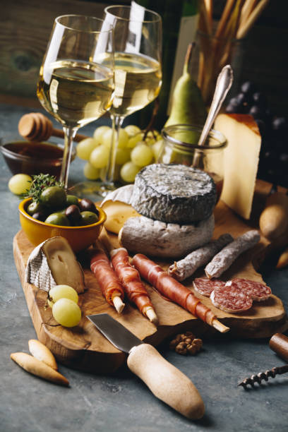 istock White wine with charcuterie assortment on the stone background 1081349210
