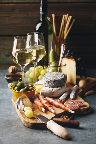 White wine with charcuterie assortment on the stone background