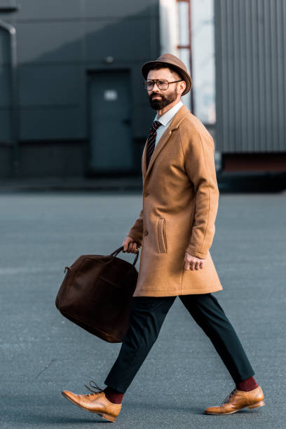 istock handsome businessman with bag walking on roof 1081349334