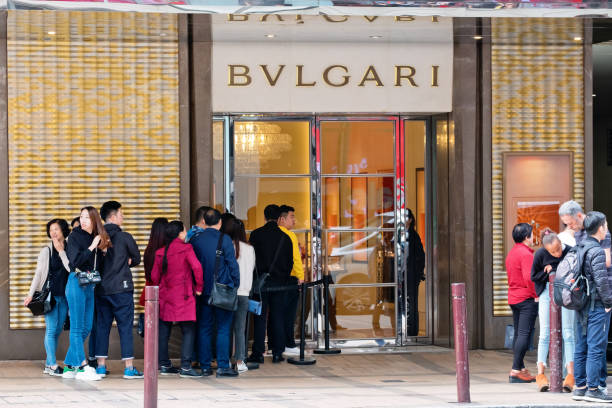 bvlgari shop in canton road, hong kong. people queuing outside and waiting to enter the store. - bulgari imagens e fotografias de stock