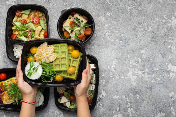 istock Plastic containers with delicious food on gray background 1081362256