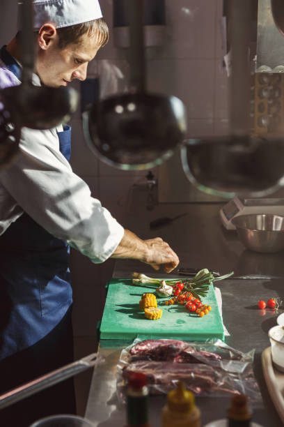 istock Chef cutting fresh vegetables for salad 1081369182