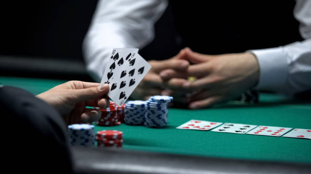 istock Casino client having weak hand combination in poker making big bet with chips 1081370186