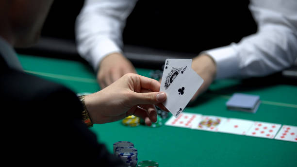 istock Businessman player has winning cards combination during poker game, two aces 1081370370