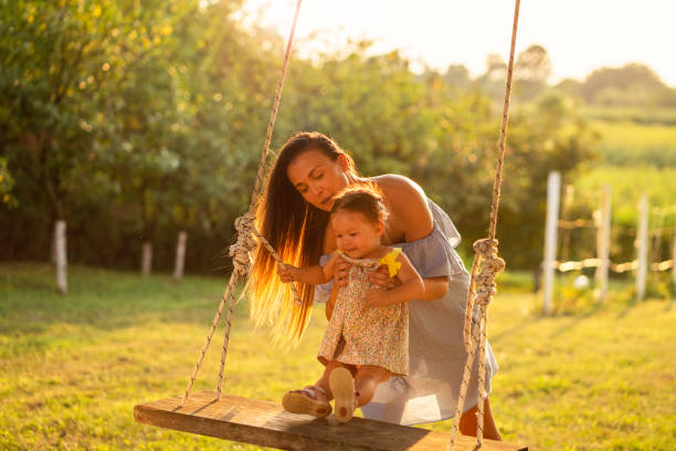 istock Mother and daughter enjoying on a swing 1081379880