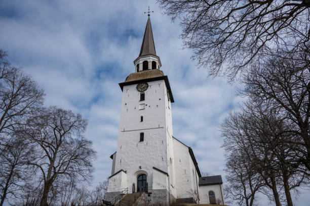 istock Old white stone church in sunlight 1081380012