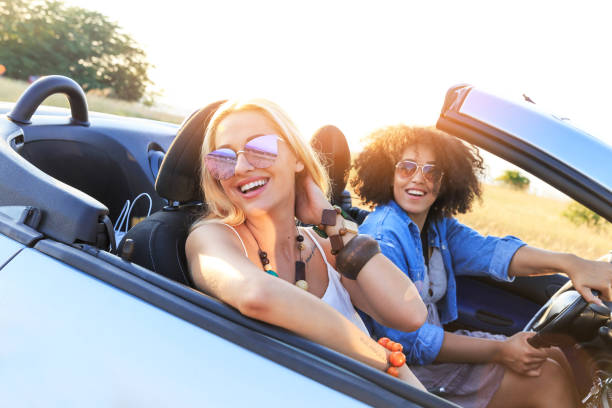 istock Girlfriends having fun on road trip 1081380050