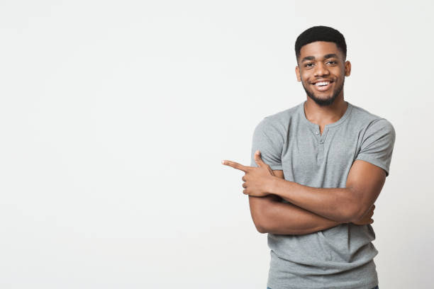 african-american man pointing aside at copy space - aside imagens e fotografias de stock