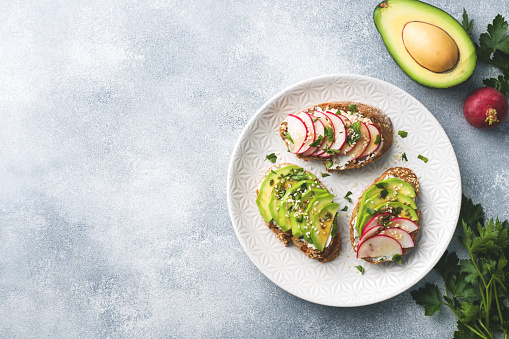 Cereal bread sandwiches with cottage cheese, fresh avocado and radish
