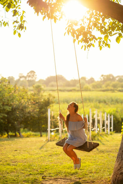 istock Beautiful woman enjoying on a swing 1081385930