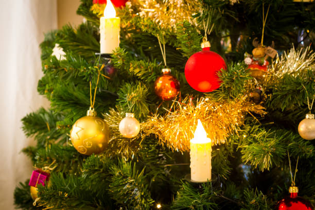 istock Decorated christmas tree with flashing lights and illuminated electric candles 1081386312