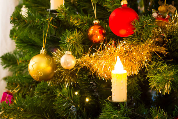 istock Decorated christmas tree with flashing lights and illuminated electric candles 1081386318