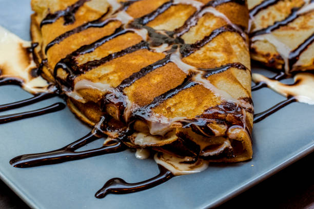 istock Fresh home made pancake with chocolate and chocolate syrup on old rustic board 1081391326