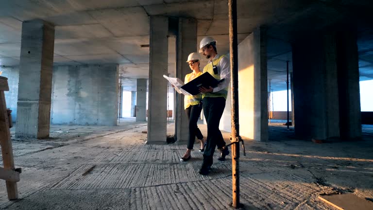 Architects walking inside a building, close up.