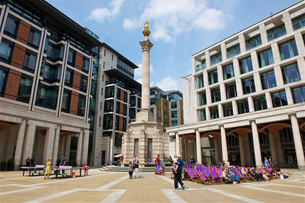 The Paternoster square in London. People walking and resting on the Paternoster square in London.Paternoster Square is an urban development.The area,once centre of the London publishing trade, was devastated by aerial bombardment in The Blitz during the Second World War. paternoster square stock pictures, royalty-free photos & images