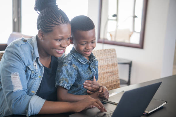 istock Mother and son using laptop and smiling 1081394022