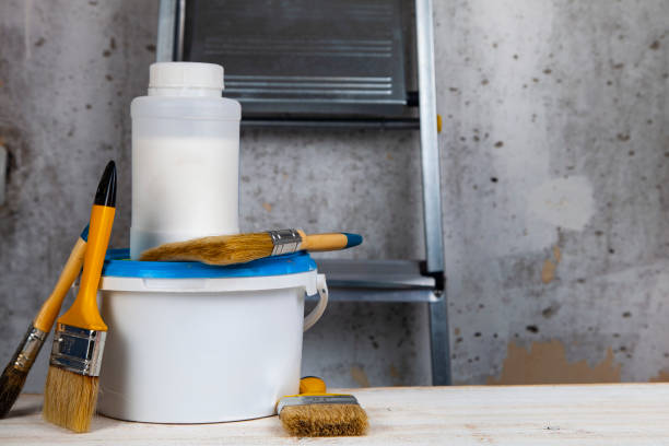 istock Paint can,roller and brush on the table. 1081395602