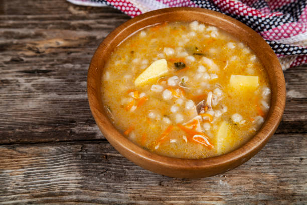 istock Pickle soup on old wooden table. 1081398660