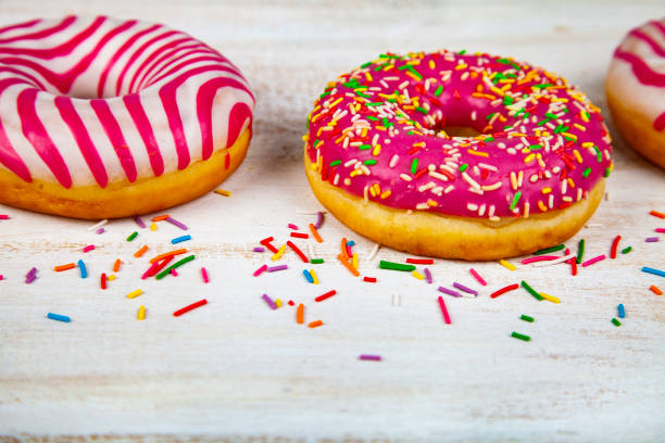 istock Pink donuts on a wooden background. 1081399760