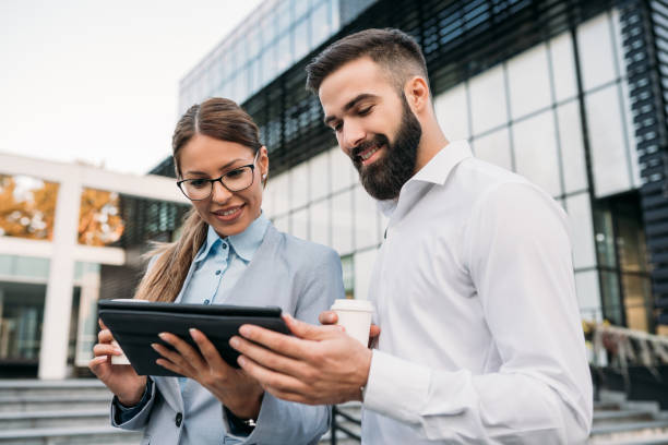 istock Male and female business people browsing on tablet computer 1081406972